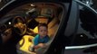 Three-year-old boy tries to drive a car.