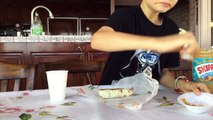 A 8 year old boy eating a taco bell burrito with ghost pepper sauce