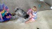 Toddler adorably entertained by puppy chewing bubble wrap