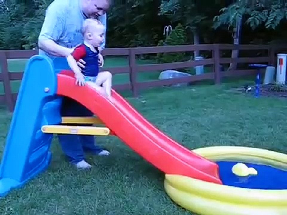 Infant Zips Into Pool on a Fast Slide