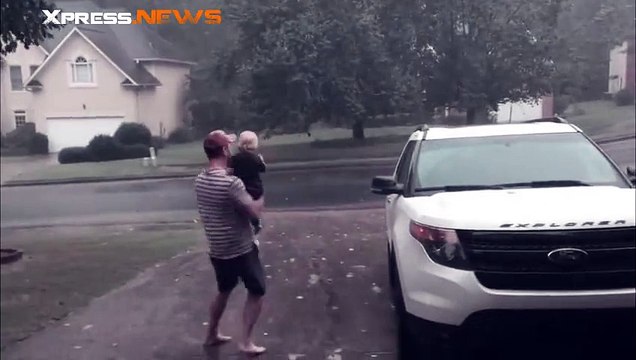 La réaction marrante d'une petite fille sous la pluie