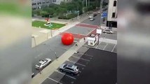 Hilarious moment security chase giant red ball down road after it escaped museum