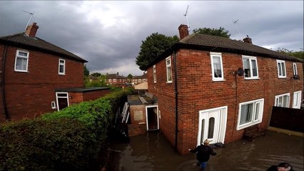Drone captures neighbours' efforts to clear flood water