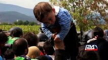 Thousands of migrants force their way over Macedonian border