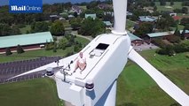 Astonishing footage shows man sunbathing on 200ft turbine