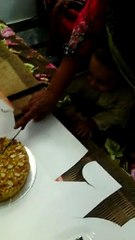 funny kid celebrating birth and cutting cake