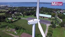 Man sunbathing on top of wind turbine spoted by drone