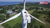 Drone filmed Guy secretly sunbathing on top of wind turbine.