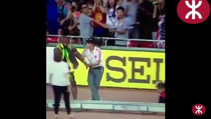 Usain Bolt hit by a cameraman after winning the Beijing World