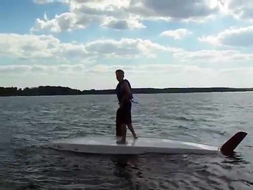 Demonstrating how to right a capsized Sunfish Sailboat