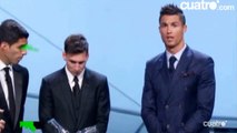 Leo Messi lets slip a cheeky smile during Cristiano Ronaldo’s speech at UEFA Best Player Award 2015
