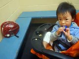 funny baby bitting a BLUE plastic cover inside the dressing room