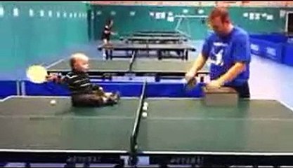 funny kid playing table tenis w_ father