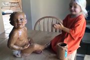 Little girl covers baby brother in peanut butter
