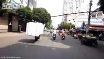 Jaw-dropping photos show intrepid delivery drivers navigating Vietnam's streets on motorbikes overloaded with balloons, trees and live FISH
