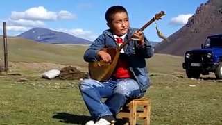 Kazak boy playing dombra