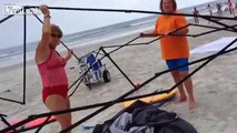 Two fat women trying to still guys Canopy from beach and thought it was there