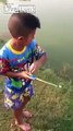 Boy catches fish with a toy fishing pole