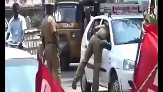Indian cops caught stealing from a car in broad daylight