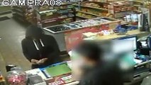 CCTV captures moment clerk slaps at robbers gun, makes robber flee
