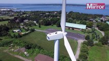 Drone Video Captures Monk Sunbathing on Top of a Wind Turbine