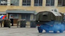 Russian armored vehicle taking a sharp turn, driving over someone