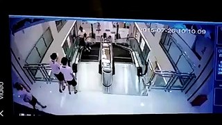 Mother crushed to death by rolling escalator, but saved her child