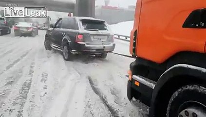 Range Rover pulls truck out of the snow.