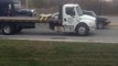 Jeep Tows Fully Loaded Semi Truck in Traffic