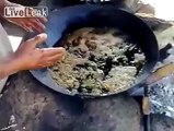 Guy dipping hands in boiling oil!