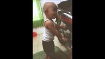 Baby 1 year old 's trying to turn on the Honda motor engine .