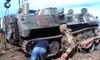 Militia fighters take armored vehicles captured from the Ukrainian military