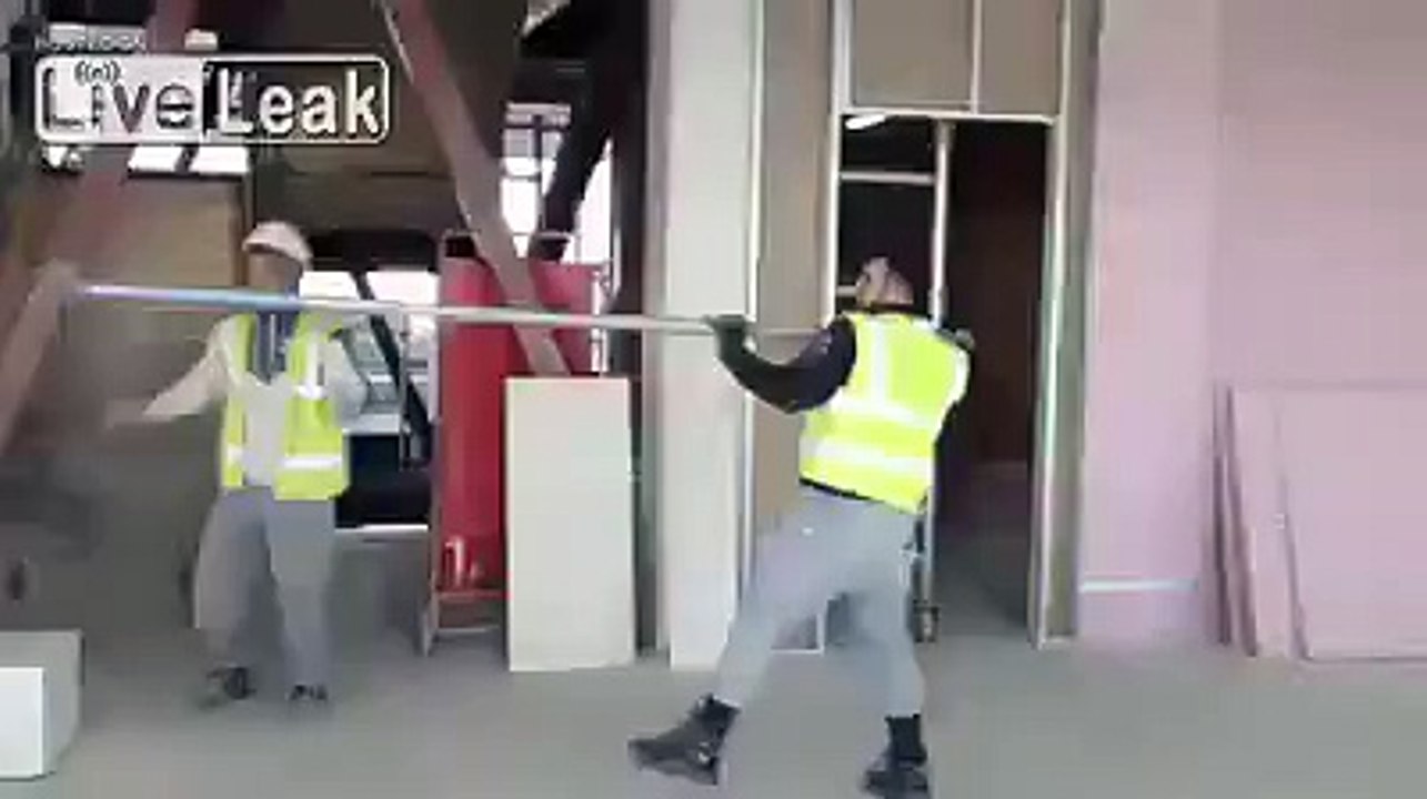 Builders pole vaulting in construction site