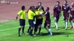 referee defends himself against ngry players who are attacking him