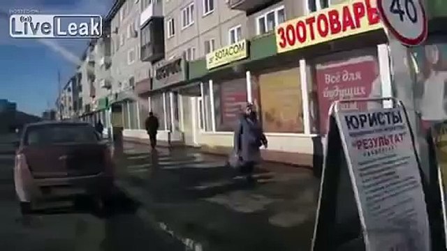 RAW Pedestrian crossing road throws beer bottle at approaching car