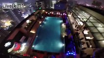 BASE JUMPER jumps off 1,200 ft Kuala Lumpur Tower = lands on pool =