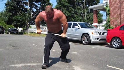 Derek Poundstone snaps a baseball bat in half