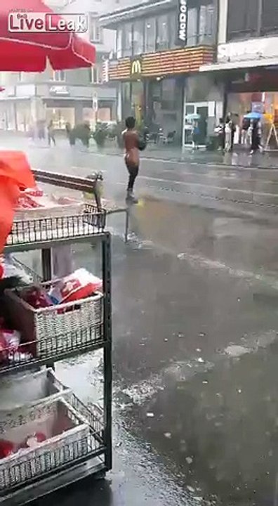 Crazy woman taking a public shower in the rain