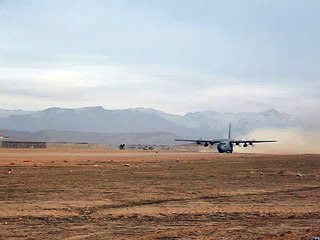 C-130 Hercules taking off, shooting flares
