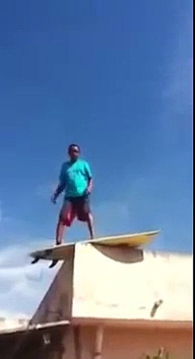 Dumb guy surfing on a roof... Epic Fail