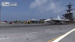 X-47B drone & F/A-18 conducts flight operations aboard an aircraft carrier.