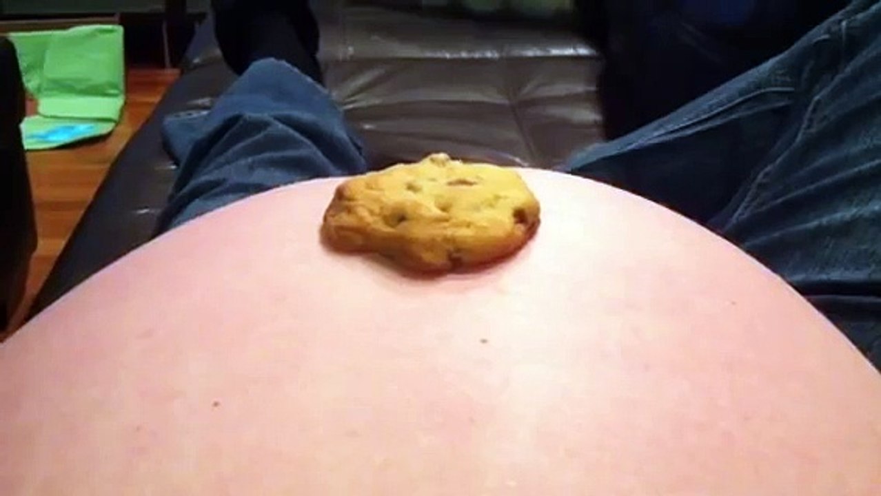 Baby in womb kicks cookie into mama's mouth