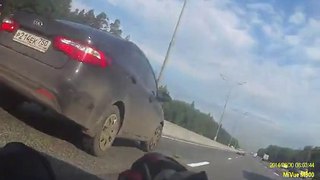 Motorcycle is clipped by a vehicle and sent tumbling down the road