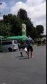 Guys fighting at petrol station