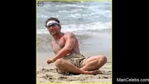 Matthew McConaughey sunbathing shirtless on a beach