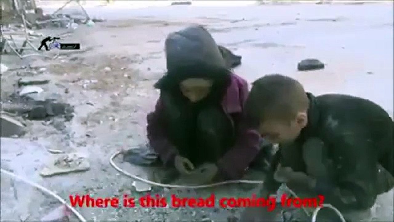 Poor kids picking bread from ground.