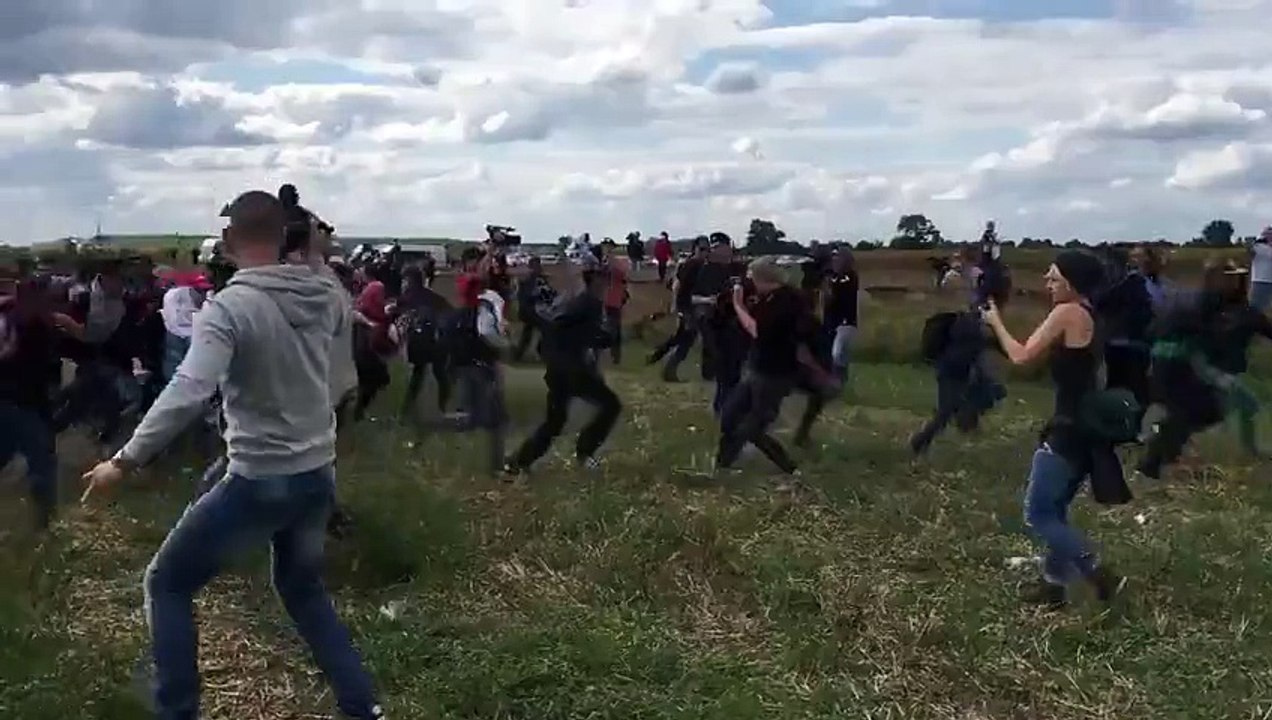 Camera Woman Trips Refugee Father Who Was Holding His Kid