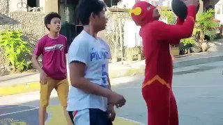 Guy in Flash Costume Schools People Playing Basketball in Manila Streets
