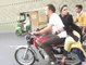 Pakistani Boy With A Girl Doing One Wheeling On Bike