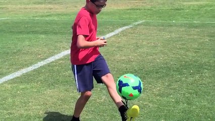 11 year old solves a rubik's cube while juggling a soccer ball